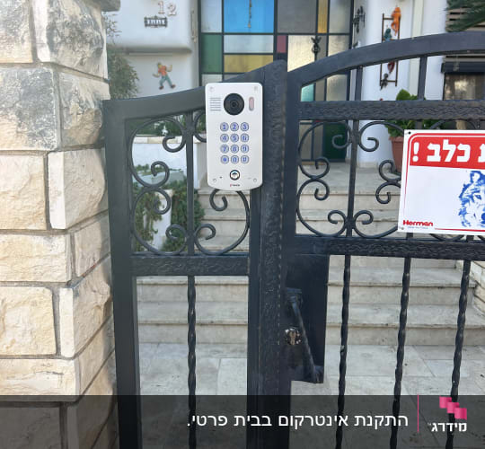 פנל אינטרקום משולב מצלמה וקודן מותקן על שער כניסה לבית פרטי